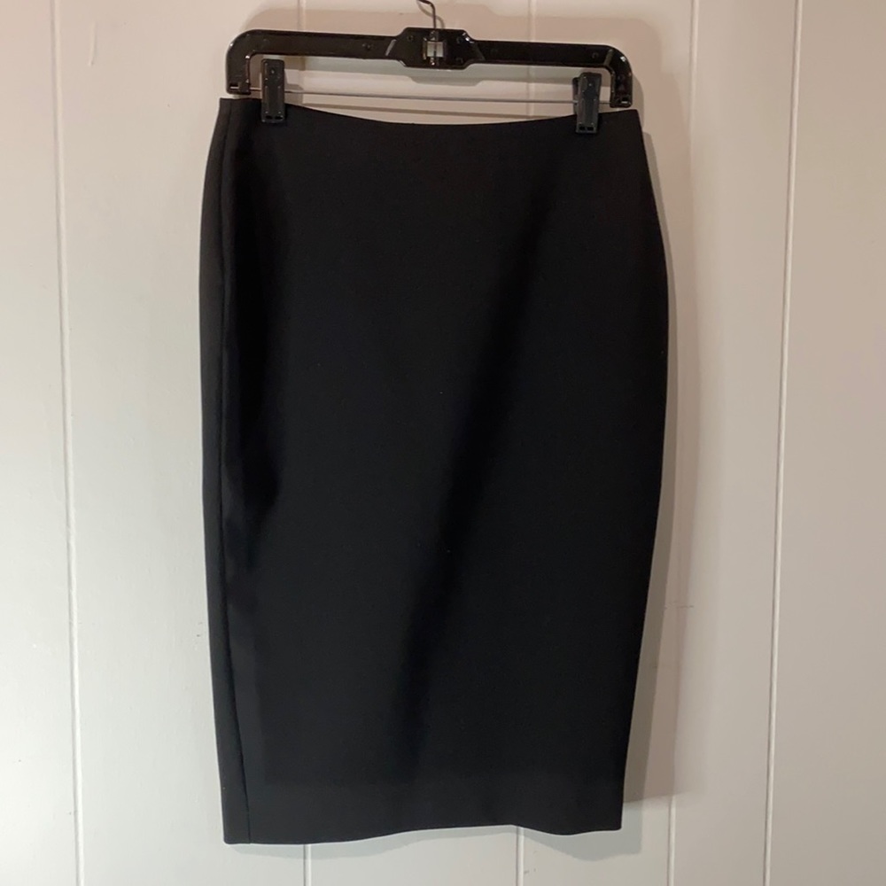 Likely black pencil skirt with zipper and slit features